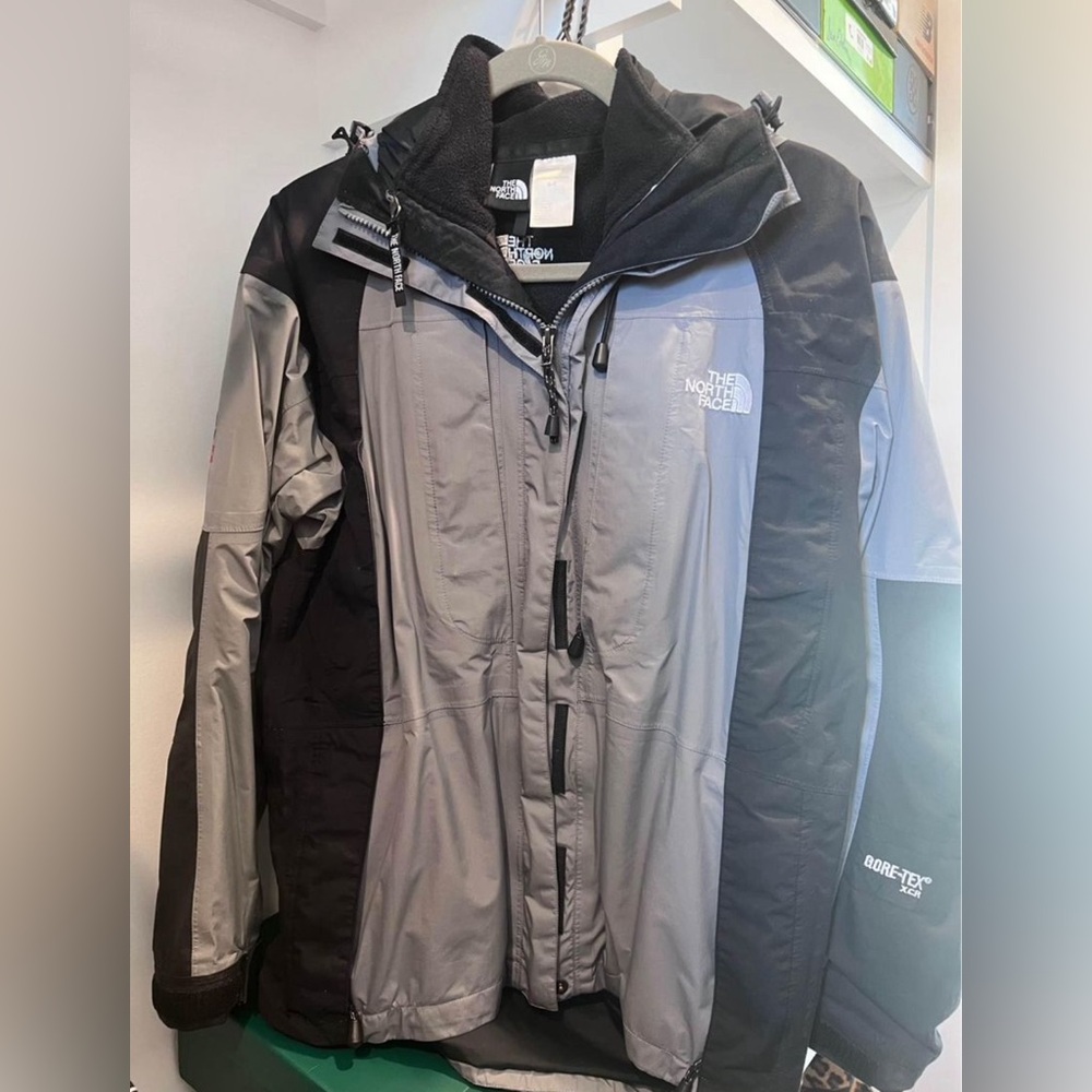 Black and Grey north face rain/ski coat with separate fleece liner.